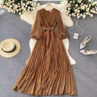 Flowy polka dot pleated dress with matching color belt