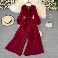 Long lantern sleeve wrap pleated jumpsuit with matching color belt