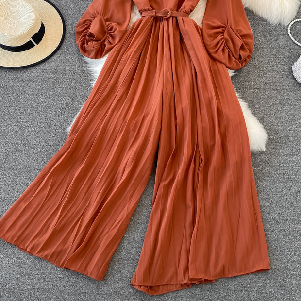 Long lantern sleeve wrap pleated jumpsuit with matching color belt