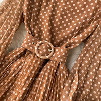 Flowy polka dot pleated dress with matching color belt