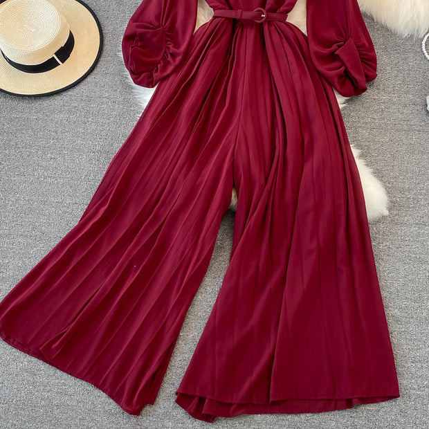 Long lantern sleeve wrap pleated jumpsuit with matching color belt