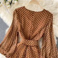 Flowy polka dot pleated dress with matching color belt