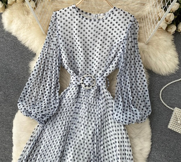 Flowy polka dot pleated dress with matching color belt