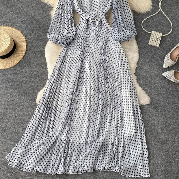 Flowy polka dot pleated dress with matching color belt