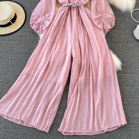 Long lantern sleeve wrap pleated jumpsuit with matching color belt