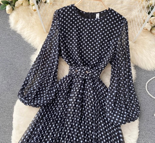 Flowy polka dot pleated dress with matching color belt